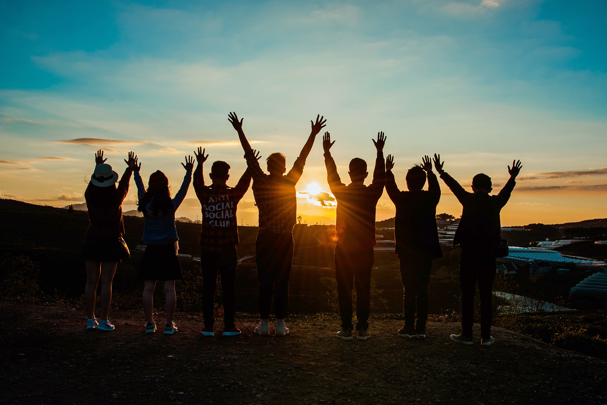 web rs sunset group hands up.jpg